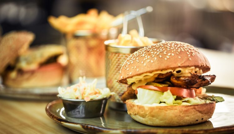 Fast food, french fries with a sandwich in a cafe, fast food concept